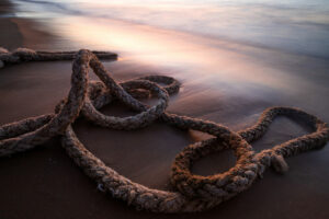 Old Boat Rope On The Beach During Sunrise